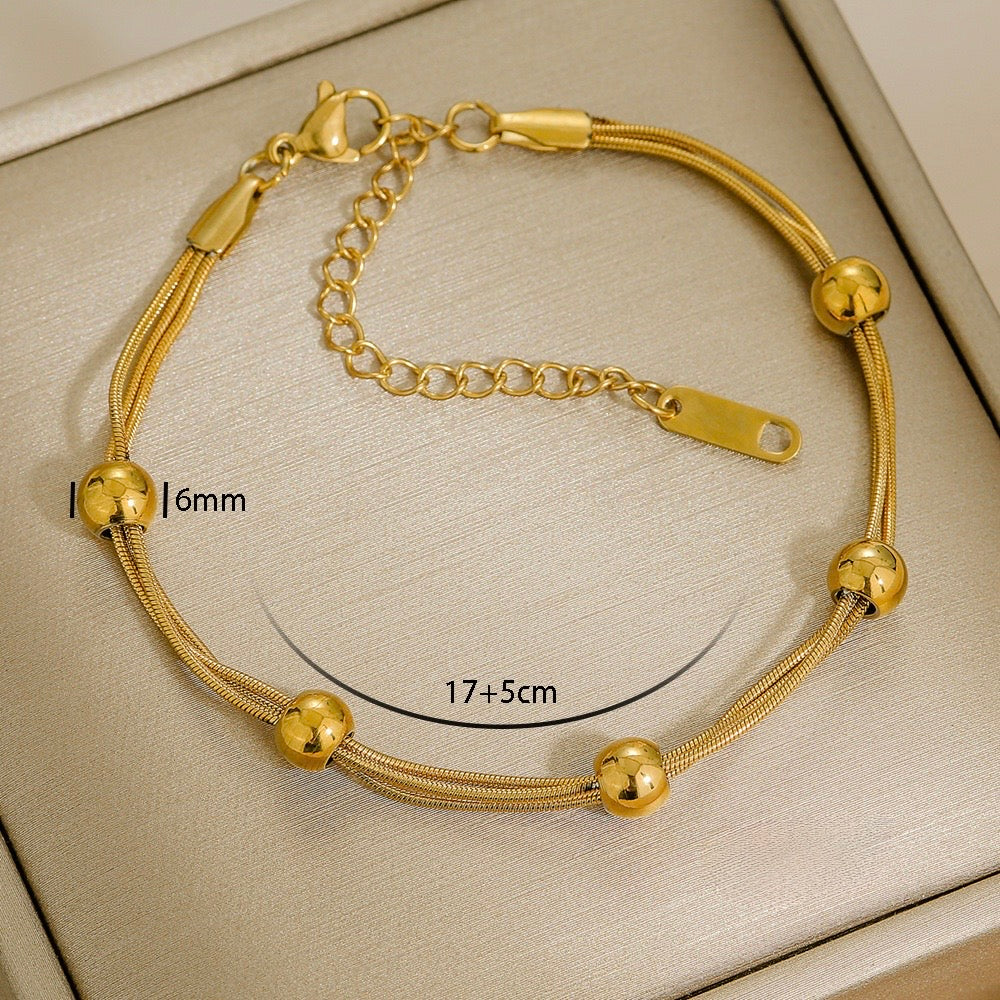 Gold Triple-Strand Bead Station Bracelet
